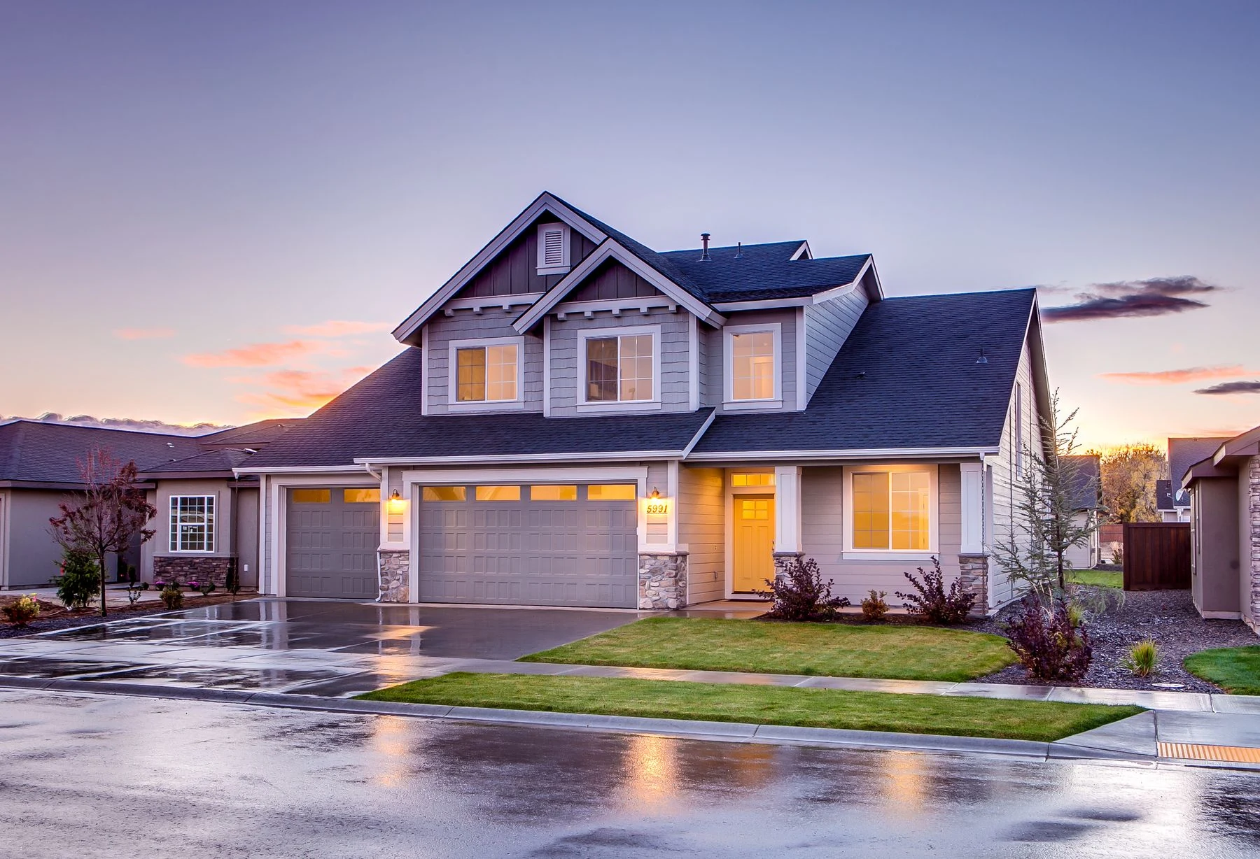 Beautiful two-storey house with a garden and warmly lit windows