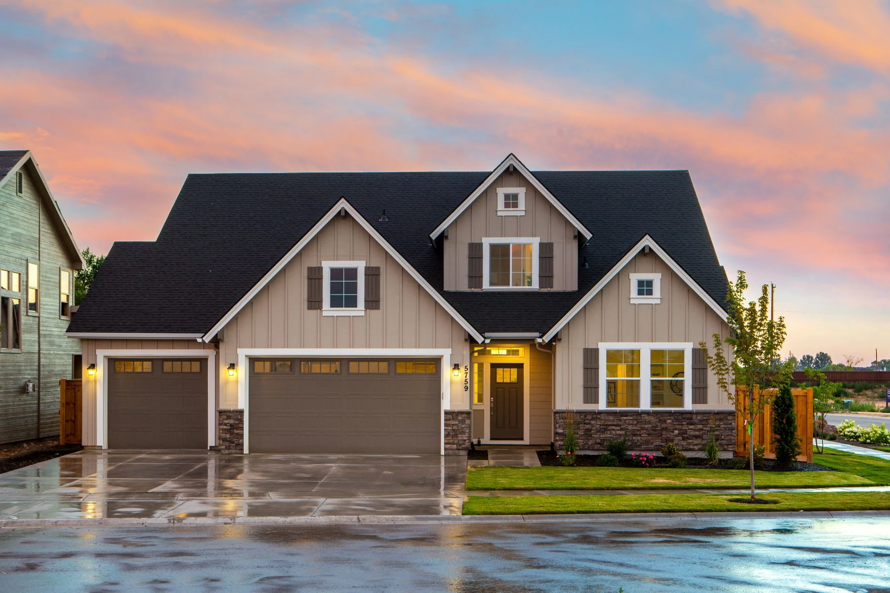Welcoming two-storey house with landscaped garden and colourful evening sky